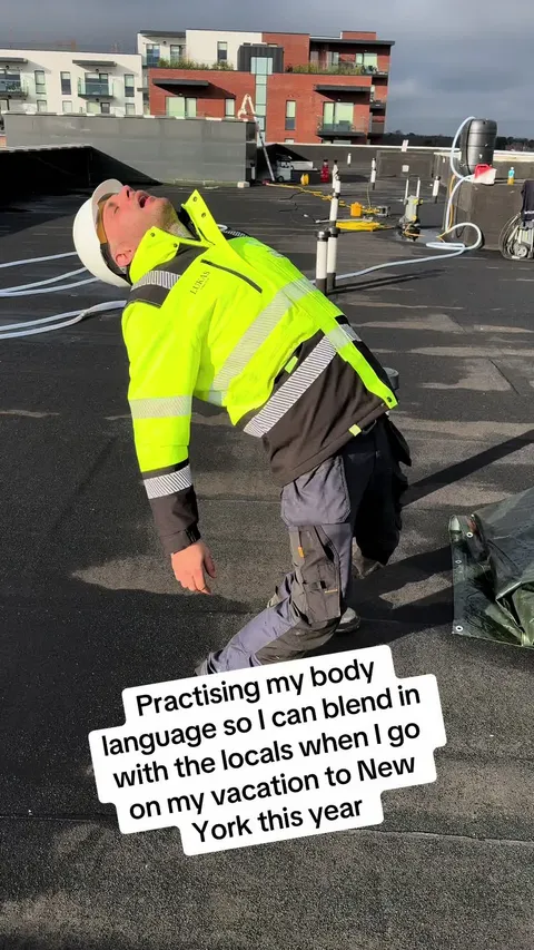 TikTok video cover: a roofer in a hi-vis jacket messing about on a flat roof above apartments